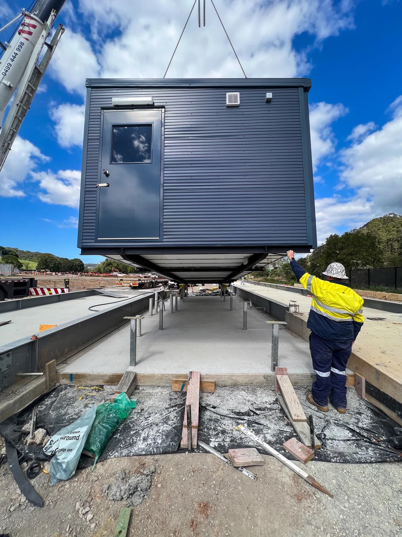 Gatehouse suspended above steel support posts during installation