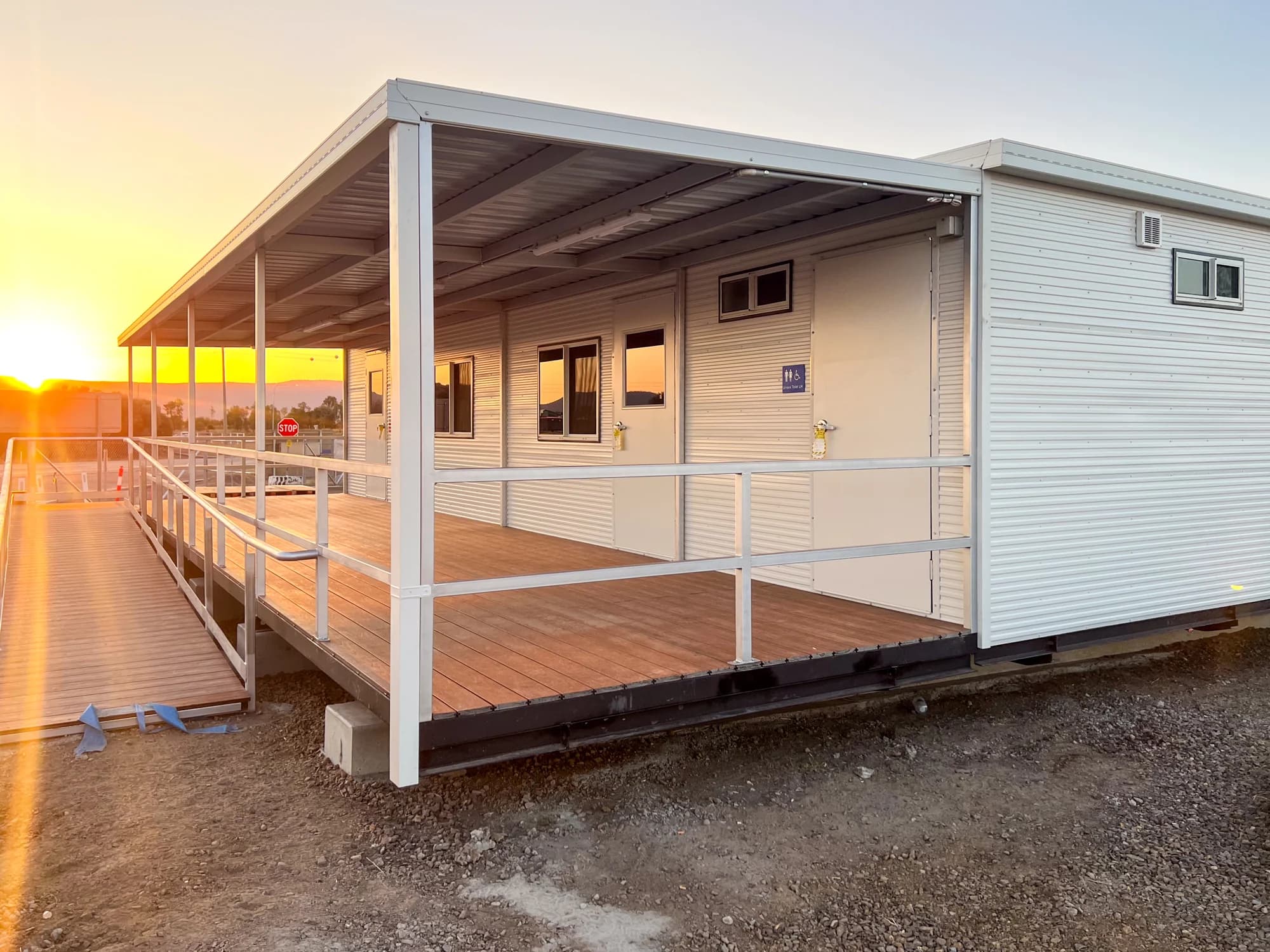 Covered Keeping Place deck with composite boards and handrails at sunset