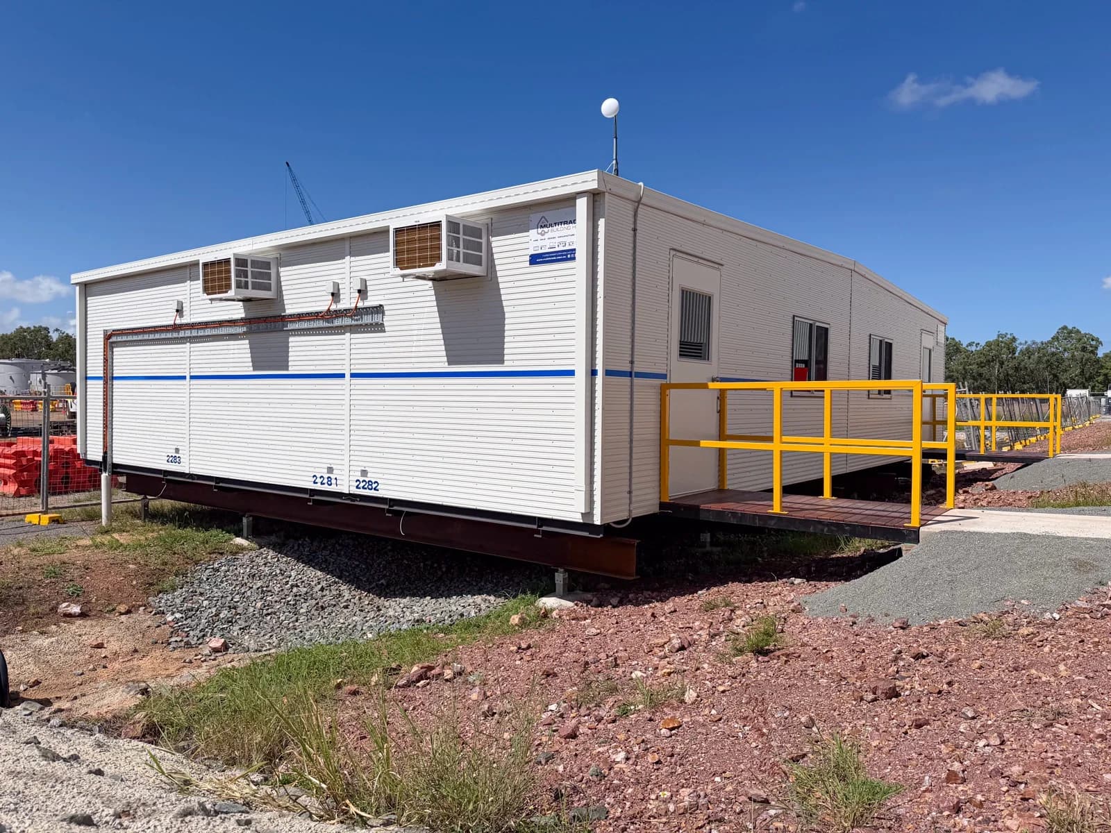 Installed office complex on raised steel beams with yellow handrails and access ramps