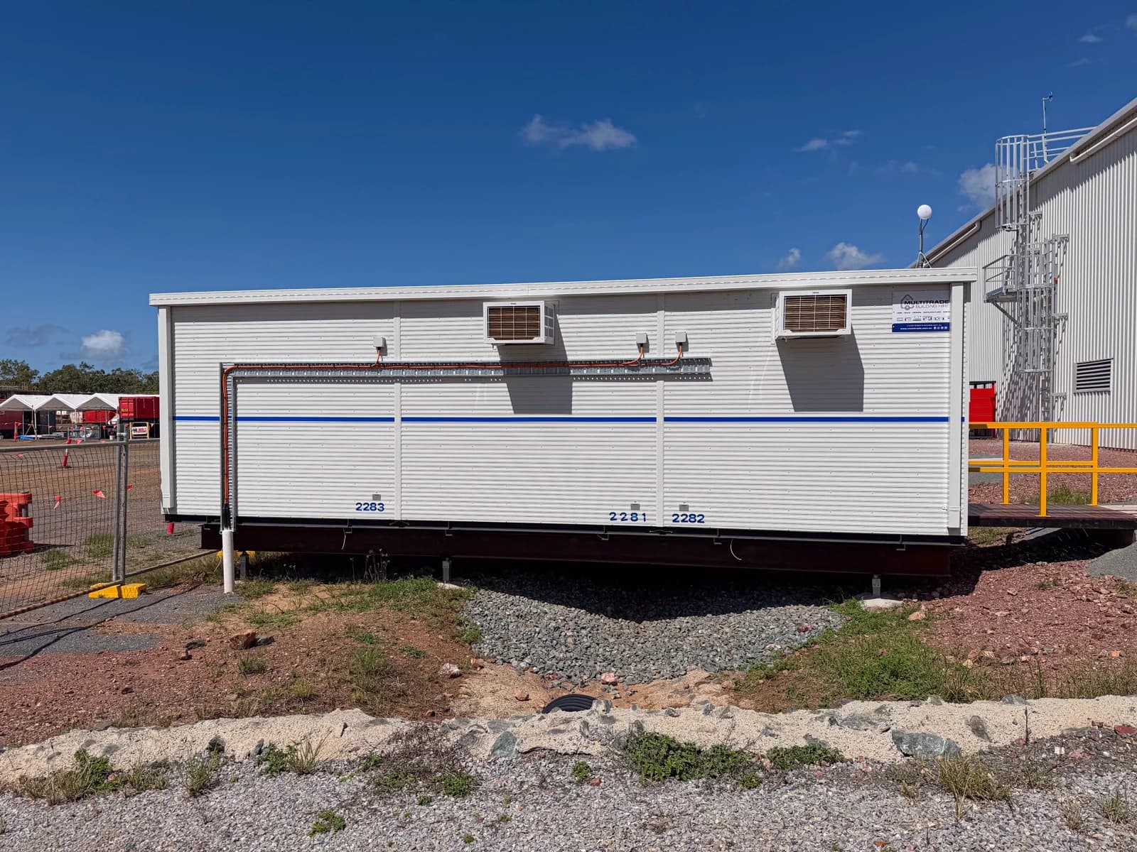 Side view of the Alpha HPA building showing steel foundation beams above a gravel drainage corridor