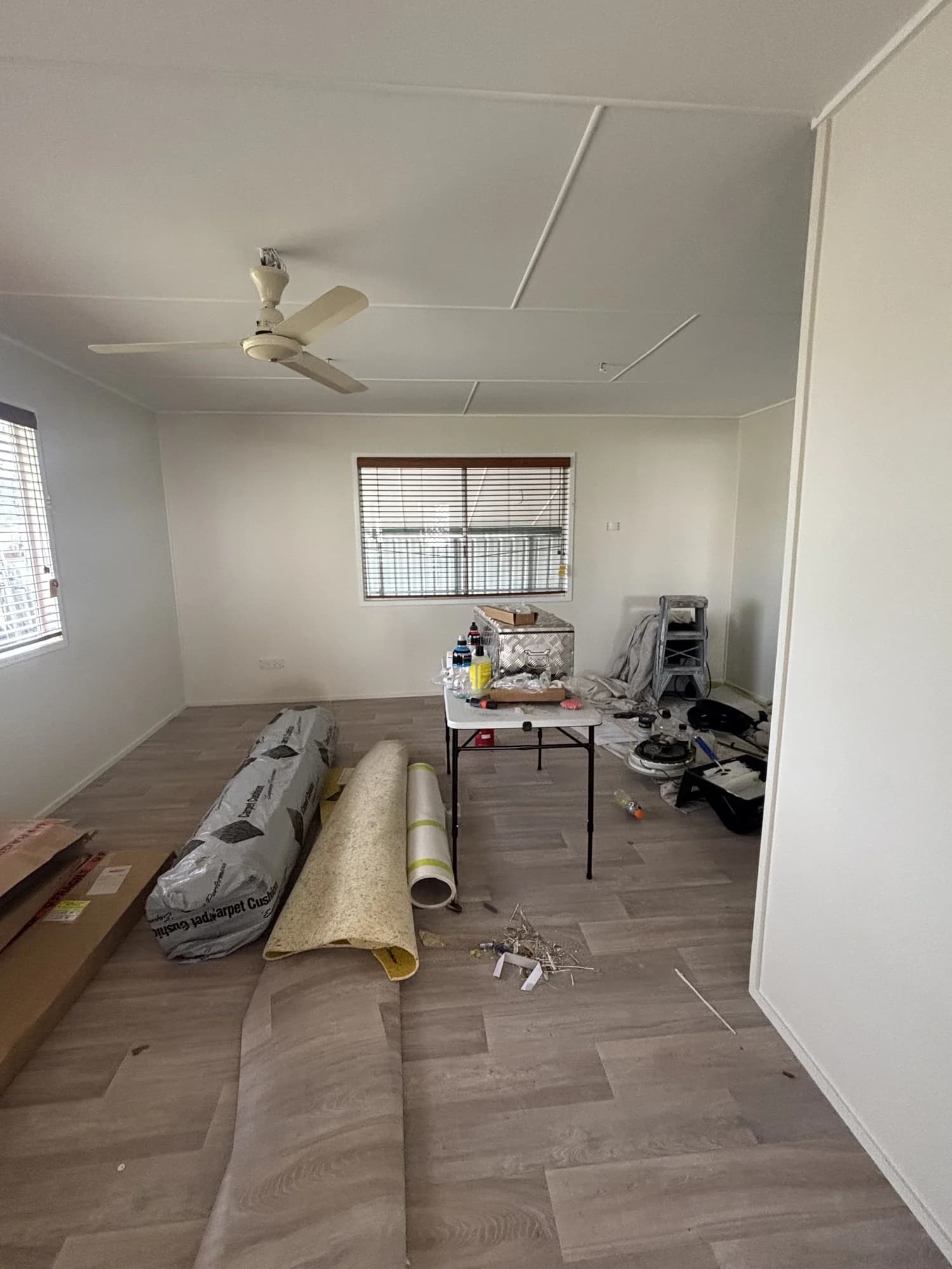 Room during residential maintenance with flooring materials, tools and work equipment